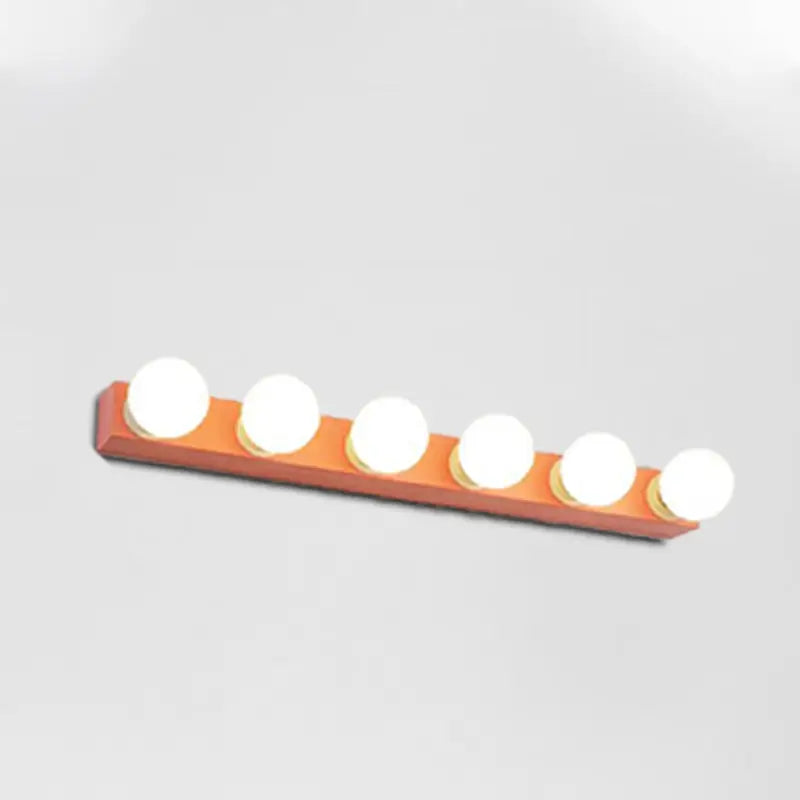 Orange rectangular vanity light fixture with five round white bulbs ideal for modern bedroom vanity lighting