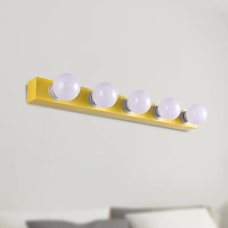 Bright yellow rectangular wall-mounted vanity light fixture with five frosted globe bulbs for bedroom use