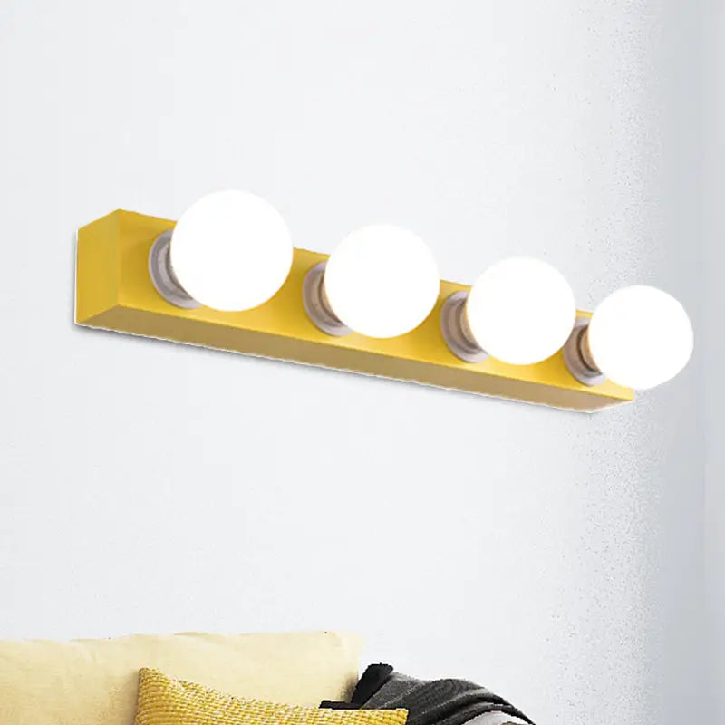 Modern orange and white rectangular vanity light fixture with four bright white bulbs for bedroom use