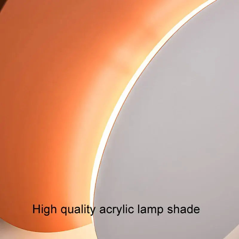 A sleek curved acrylic decorbites led wall light with warm orange glow and smooth white edge for living room