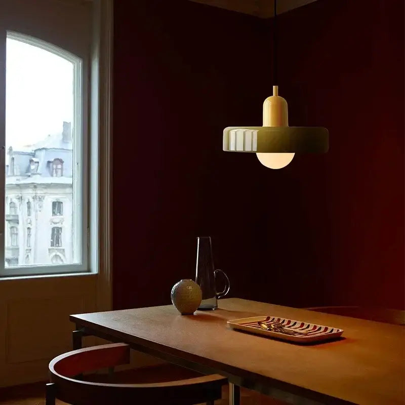 A modern pendant light with a matte olive-green ribbed shade and cream top for a glass led macaron ceiling chandelier