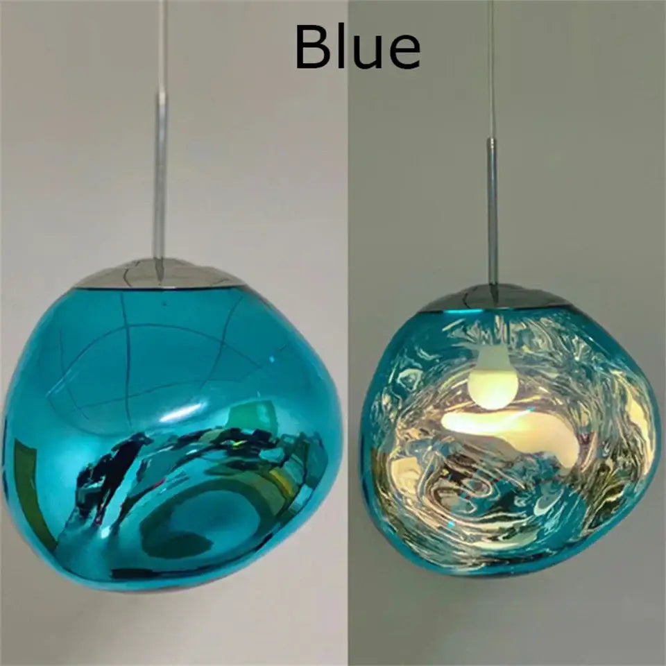 Modern organic form blue glass pendant light with swirling reflective surface and chrome plated finish for kitchen trio