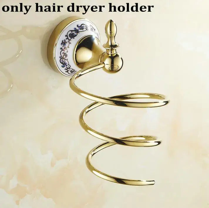 Gold-toned spiral hair dryer holder with blue floral porcelain base in modern ornate gold and white bath hardware set