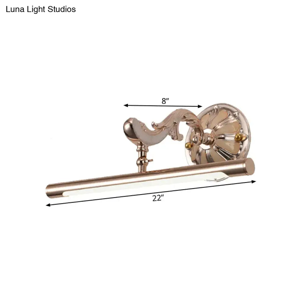 A sleek brushed nickel wall mount bathroom lamp with ornate curved arm and long cylindrical led bar light fixture