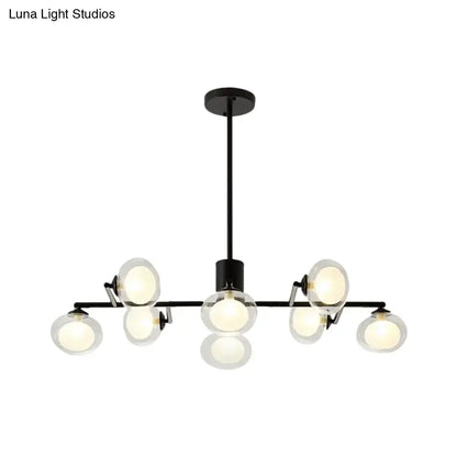 Black metal chandelier with eight frosted glass globe bulbs for modern black white decor by DecorBites™