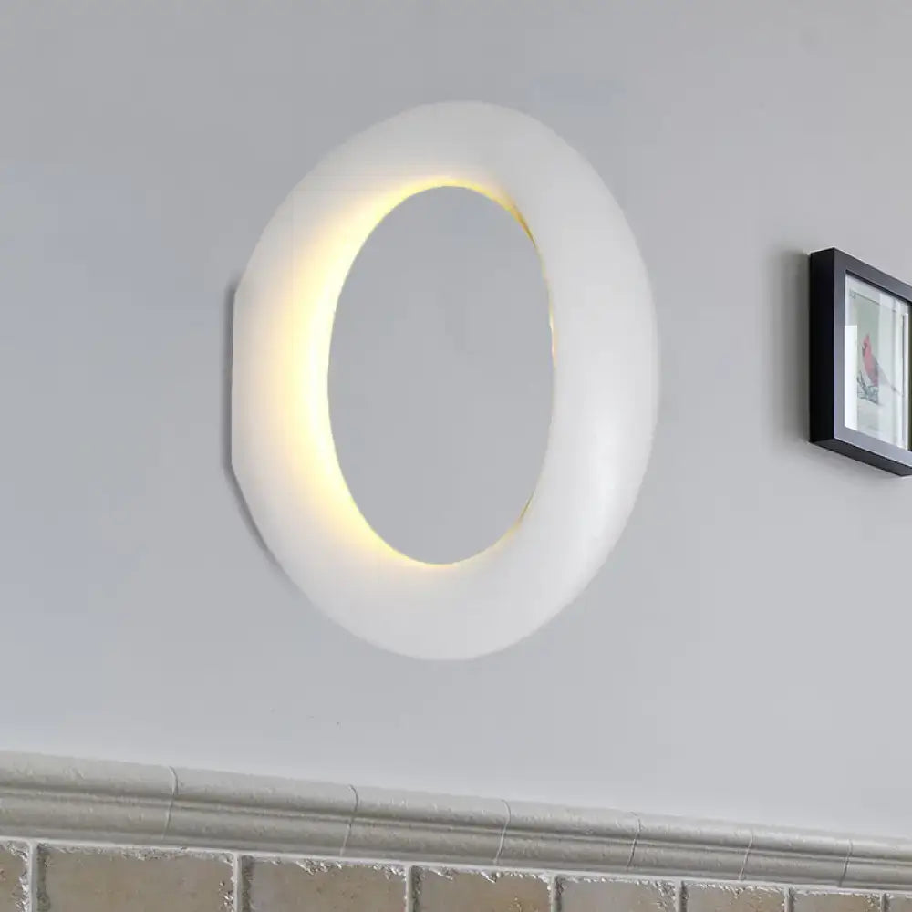 Modern oval black and white led mirror bedroom wall light 110v-120v with white oval-shaped sconce and glowing yellow light ring