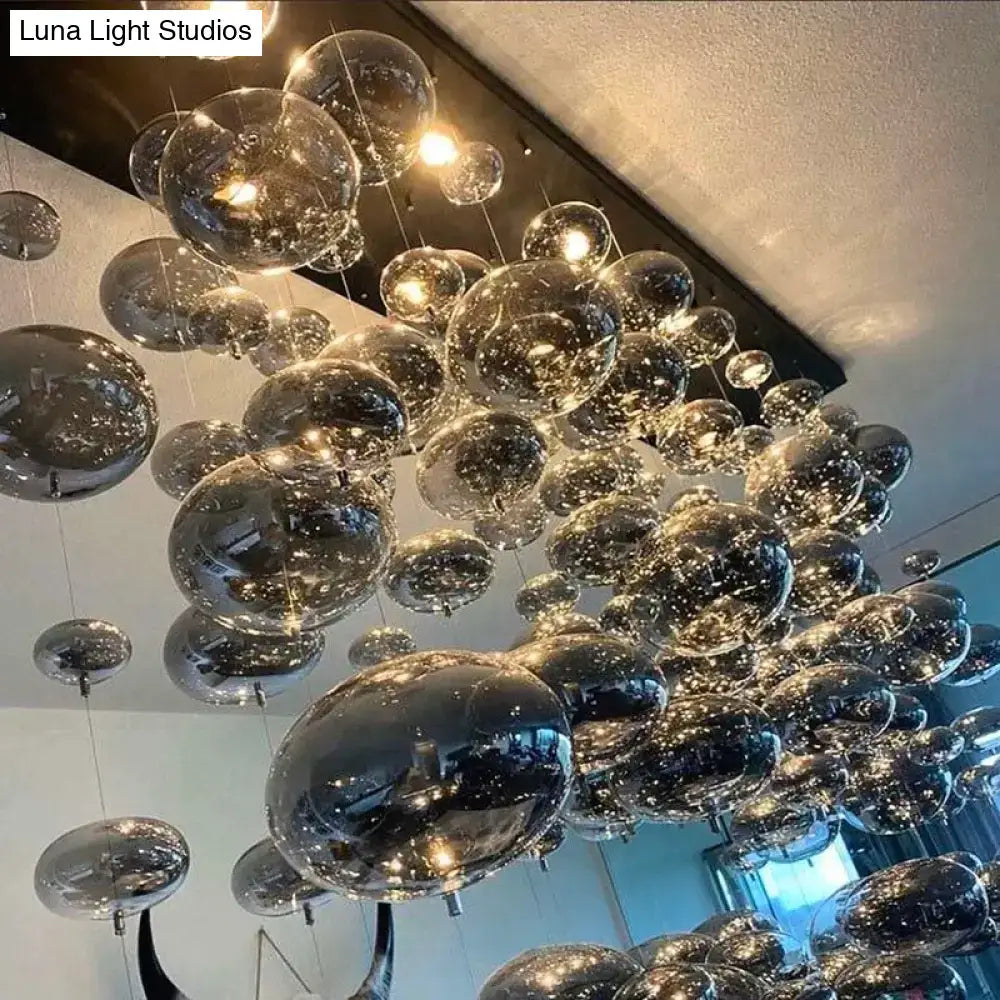 DecorBites™ modern oval bubble ball LED chandelier with transparent glass spheres and metallic interiors for dining room lighting