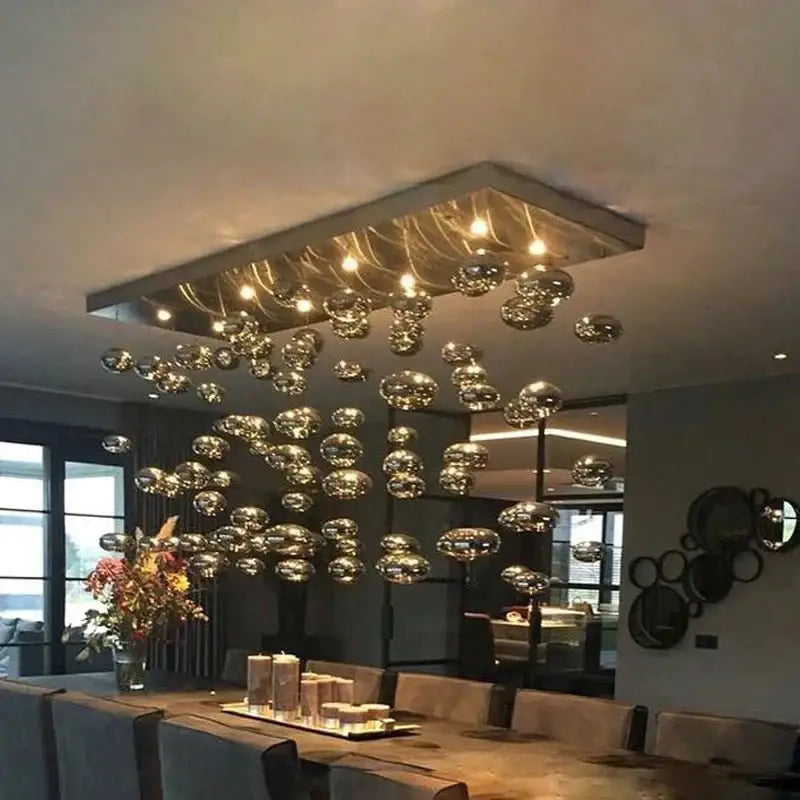 Modern oval bubble ball silver chandelier with metallic glass orbs suspended in a rectangular frame for dining room lighting