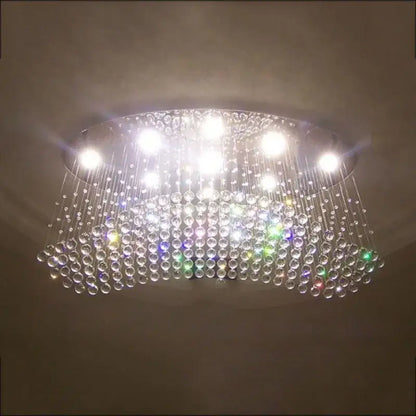 Modern oval crystal flush mount chandelier with cascading clear glass beads and bright white led lights for dining room