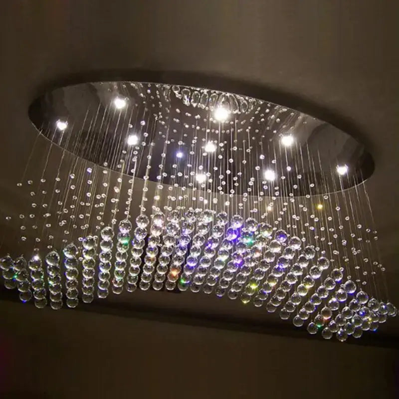 Modern oval flush mount chandelier with cascading clear and multicolored glass beads on a sleek metallic frame