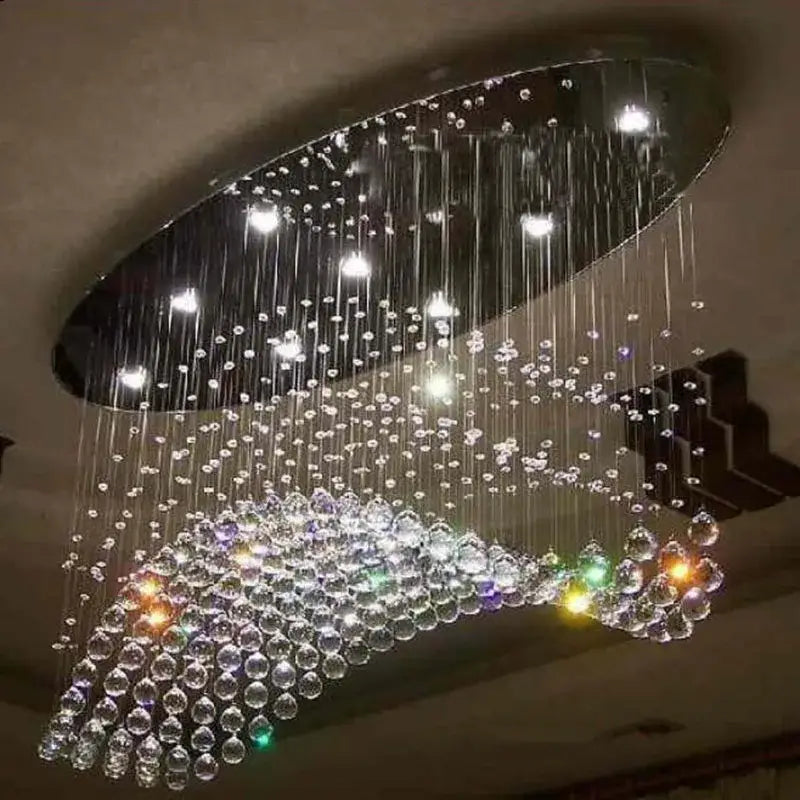 Modern oval crystal flush mount chandelier with cascading clear and multicolored glass beads on a dark metal frame