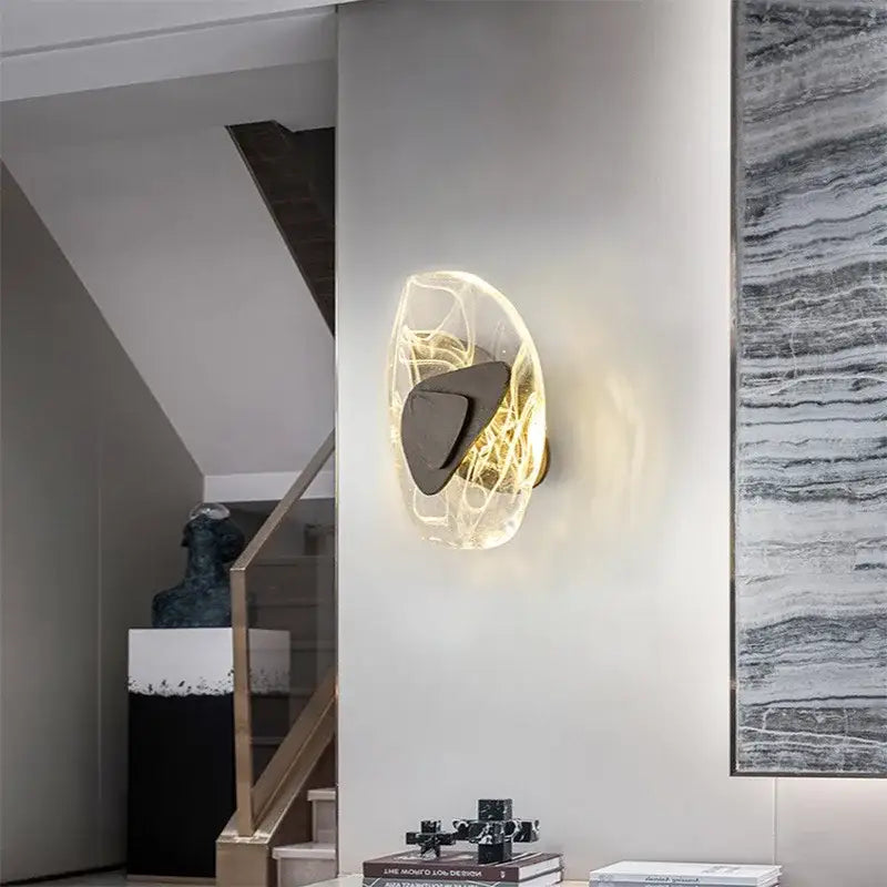 Modern oval crystal wall lamp with translucent organic glass diffuser and dark metallic accent for bedroom use