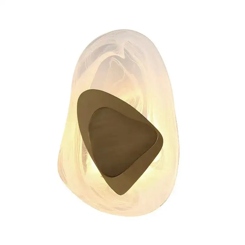 Modern oval crystal wall lamp with translucent amber resin and polished bronze cutout designed as a bedroom wall lamp