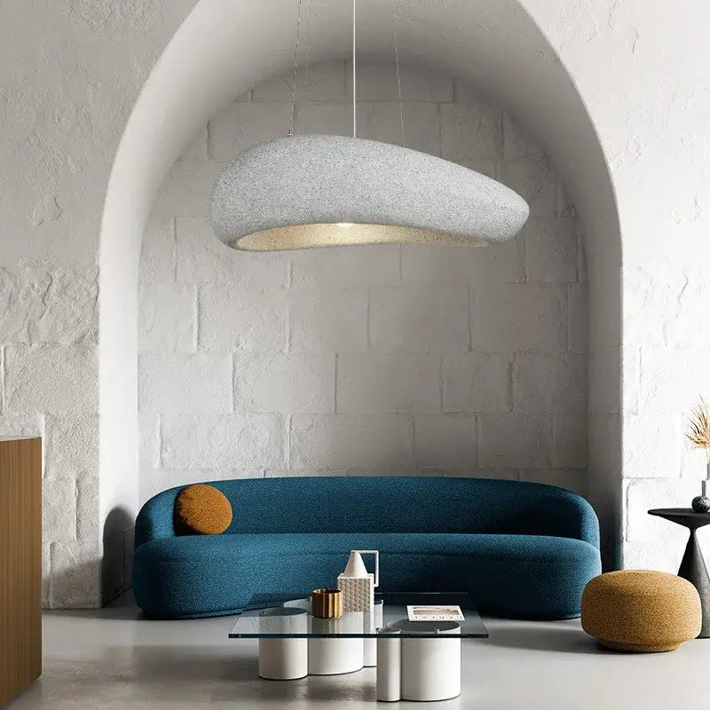 A modern oval gray and gold pendant light with textured fabric and warm glow for decorbites loft dining room decor