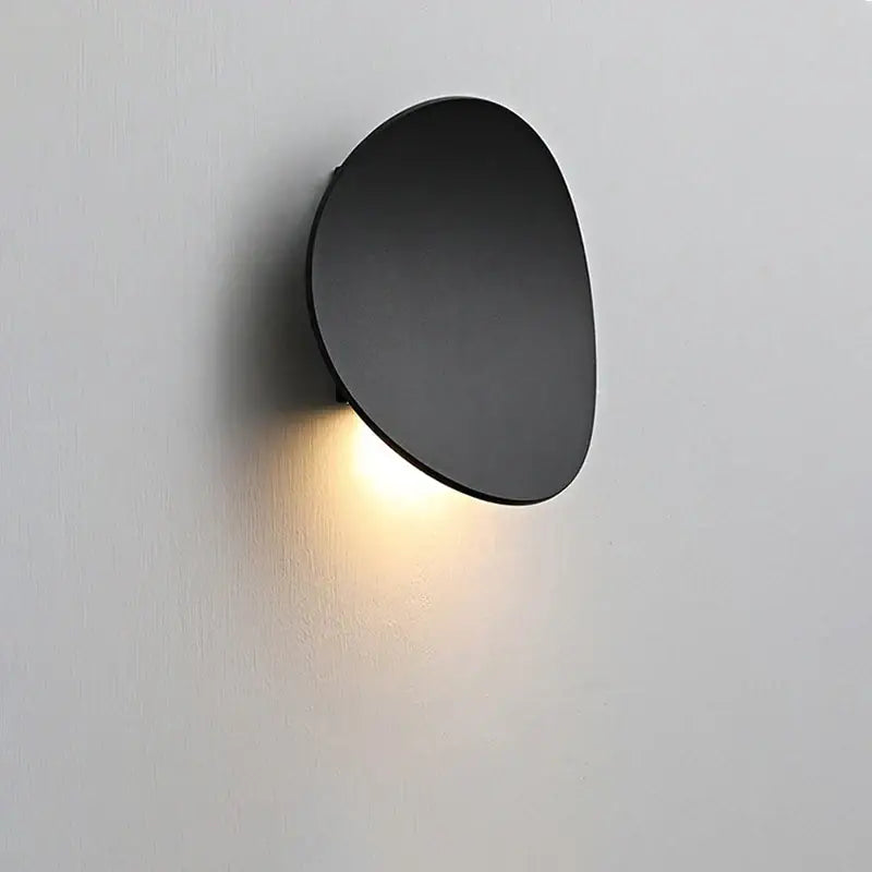 Black matte-finished modern oval led wall lamp with soft warm glow for garden waterproof lighting use