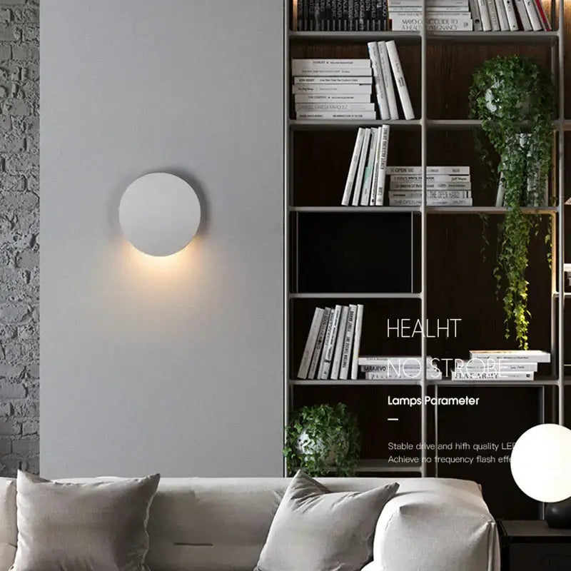 Minimalist white circular led wall lamp emitting warm glow suitable for modern oval gray waterproof garden lighting