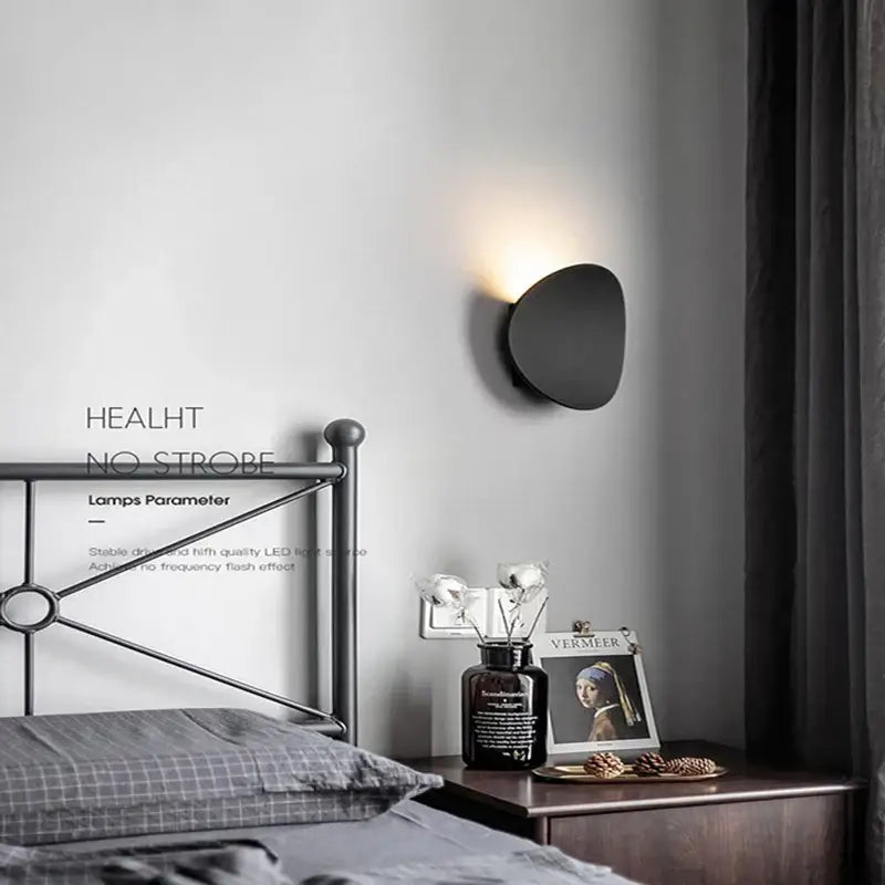 Black matte-finished modern oval led wall lamp with smooth organic shape for garden waterproof lighting