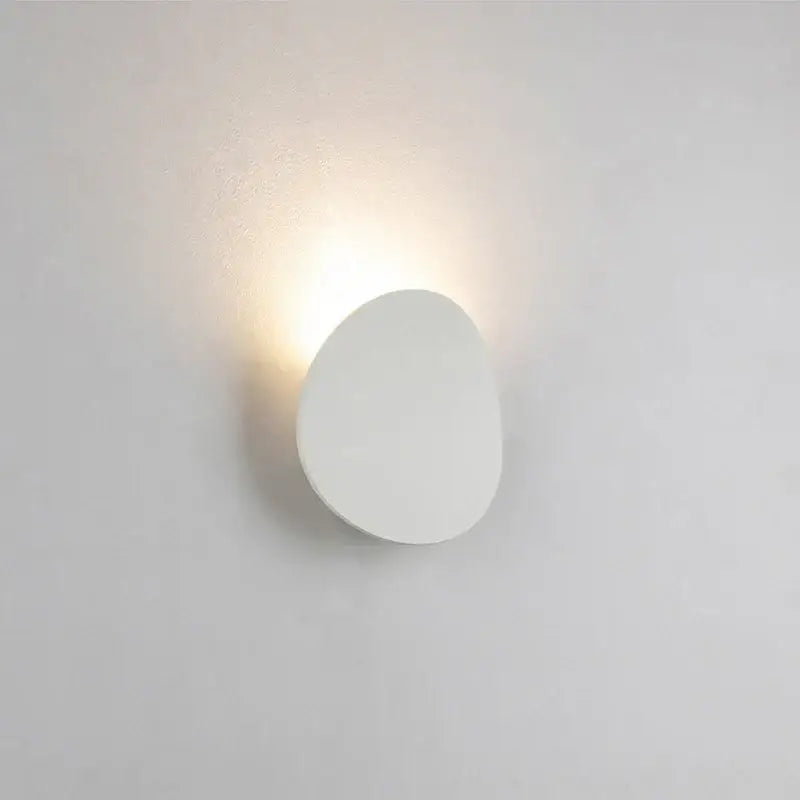 Minimalist modern oval gray and dark gray led wall lamp with smooth organic shape and soft ambient lighting