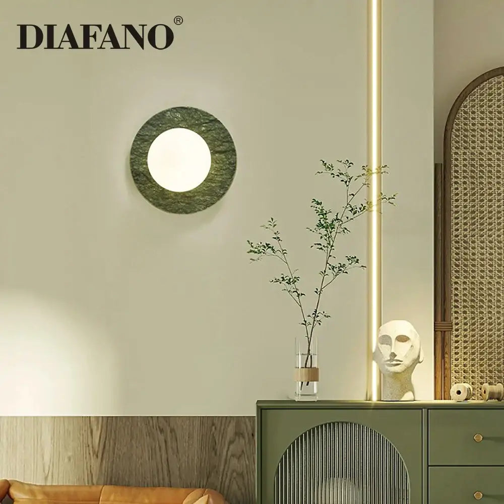 Modern oval green marble wall lamp with a circular polished stone sconce and central illuminated circle decorbites green marble