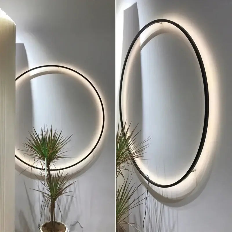 Modern oval led wall sconce with sleek black frame and warm glowing decorbites led ring for bedroom mirror lighting