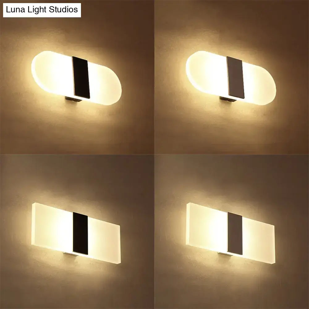 Modern oval rectangular convex wall sconce with frosted glass panels and black rectangular accent for bedroom lighting