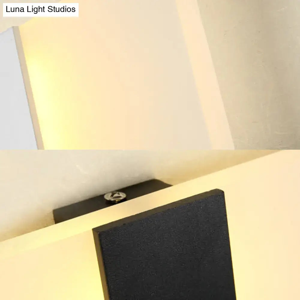 Black rectangular modern oval rectangular convex wall sconce with textured surface and metallic screw detail for bedroom