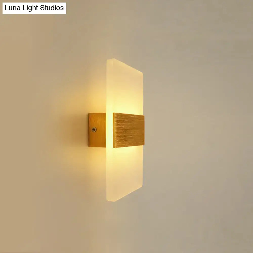 Modern oval rectangular convex led wall sconce with brushed gold metal base and frosted glass emitting warm light