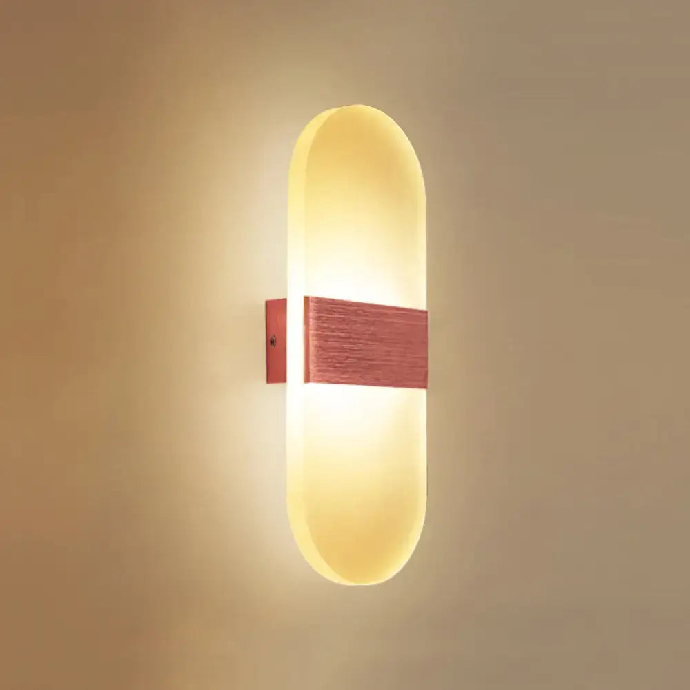 Modern oval rectangular convex led wall sconce with warm yellow glow and reddish-brown wooden accent for bedroom lighting