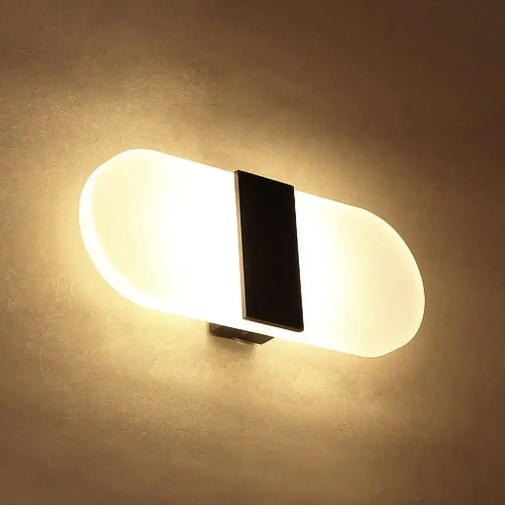 Modern oval rectangular convex wall sconce with frosted white diffuser and central black rectangular accent for bedroom lighting