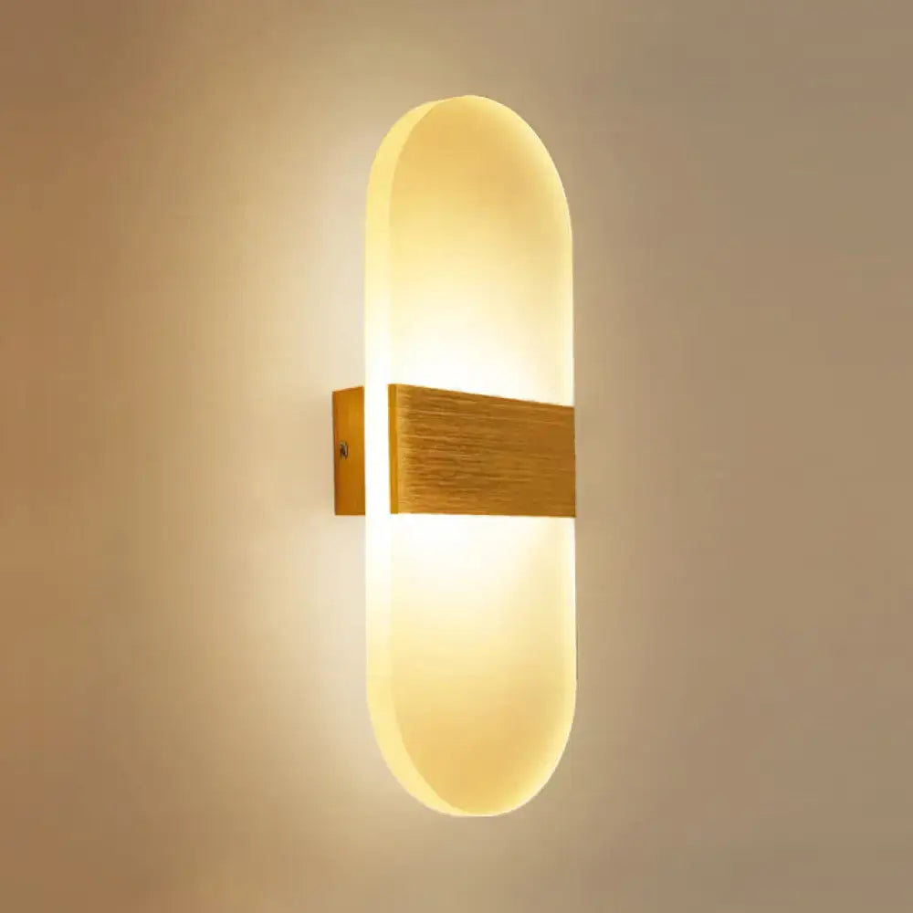 Modern oval rectangular convex led wall sconce with warm-toned frosted glass diffuser and brushed brass accent bar for bedroom lighting