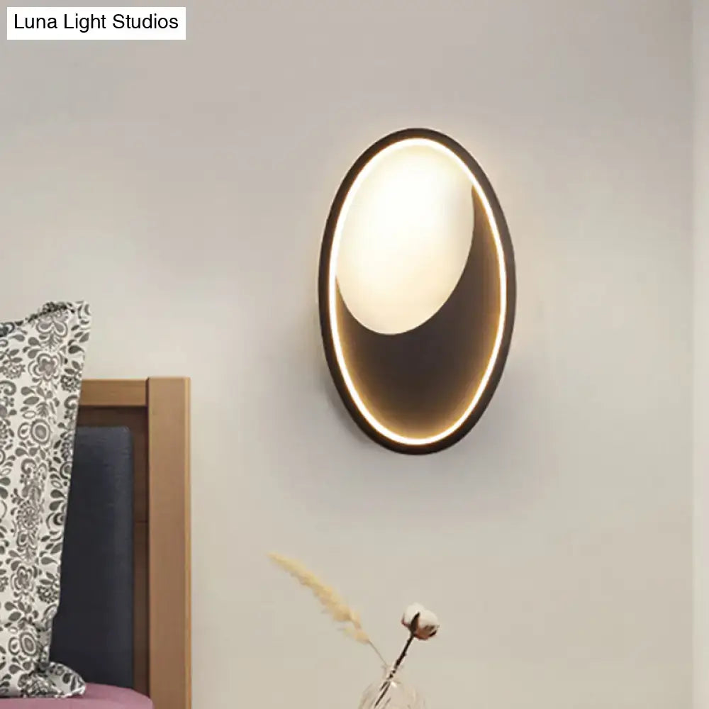 Modern oval wall lamp with sleek black frame and warm glowing led light for 110v-120v or 220v-240v use