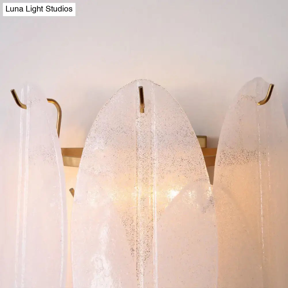 Modern oval white glass leaf wall sconce with translucent frosted glass and gold-toned metal hooks for hallway lighting