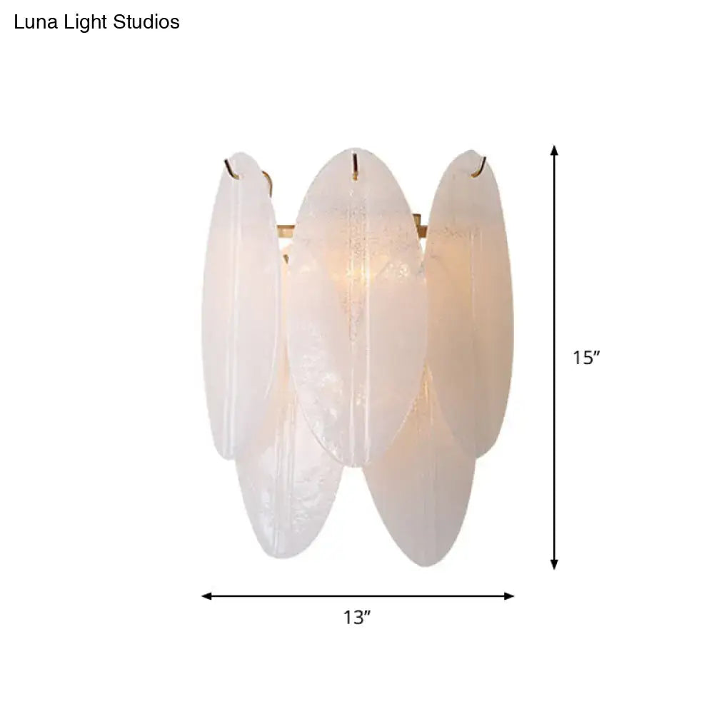 Modern oval white glass wall sconce with three frosted glass leaf panels and gold-toned metal accents for hallway lighting