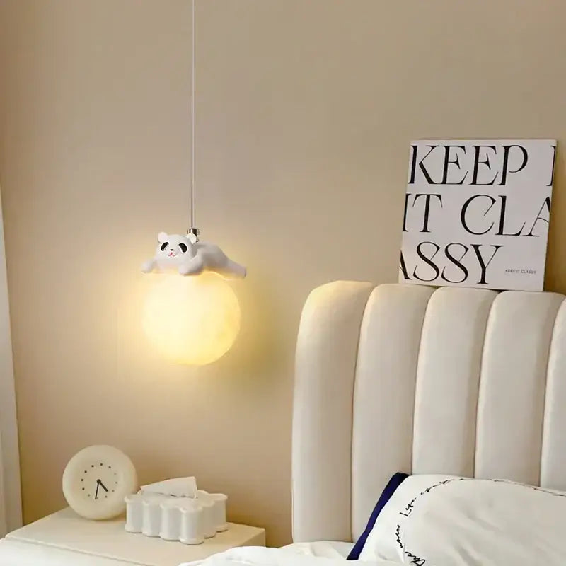 A soft glowing white glass panda bear bedroom wall lamp with plush texture and dangling cord for decorbites bear bedroom