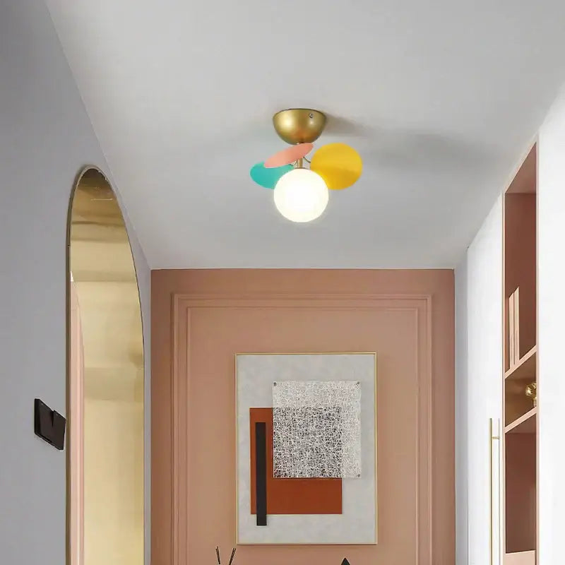 Modern pastel balloon ceiling light fixture with brass base and colorful pink yellow teal shades for kids bedroom