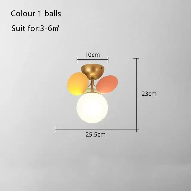 Modern pastel balloon ceiling light fixture with three yellow orange and white glass bulbs on brass ceiling light base