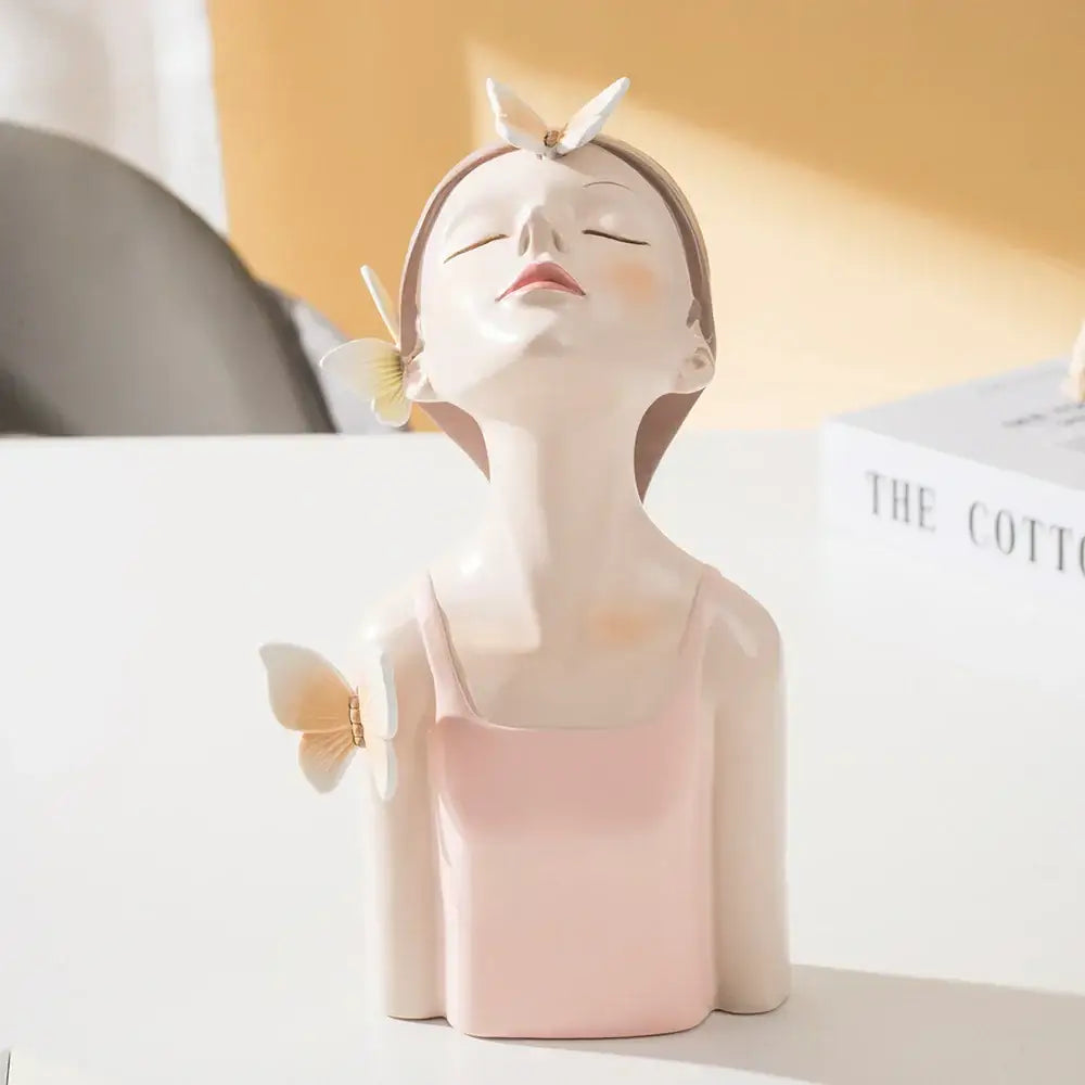 Delicate porcelain butterfly girl sculpture featuring a woman in pink with white butterflies for bedroom decor