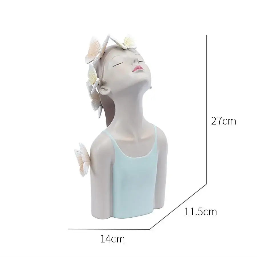 A serene light blue resin butterfly girl sculpture with closed eyes and butterflies in her hair for bedroom decor