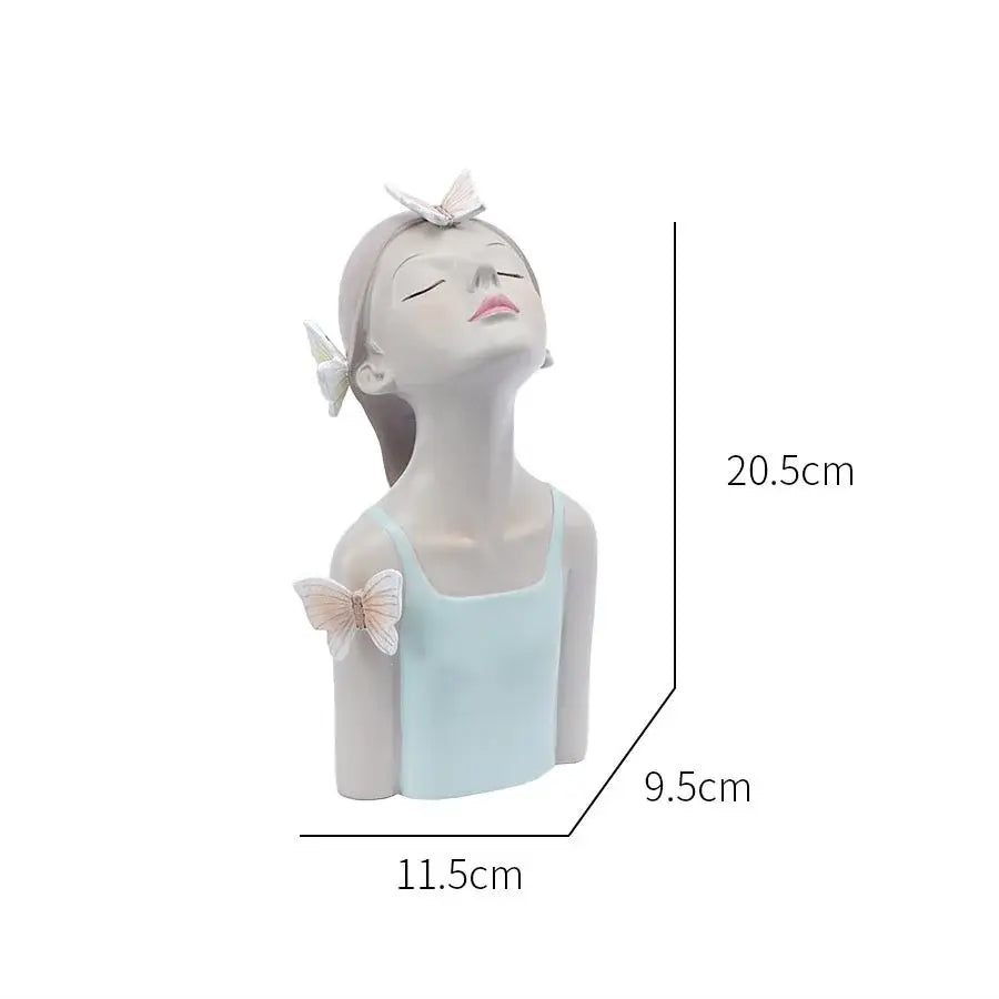 A serene light blue and white resin butterfly girl sculpture with closed eyes and delicate butterfly accents for decor