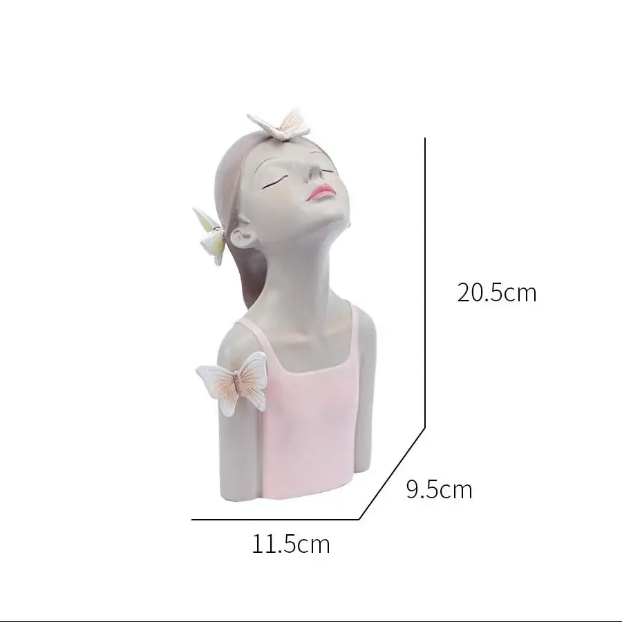 Delicate pink and white resin butterfly girl sculpture wearing blush tank top with three small butterflies for bedroom decor