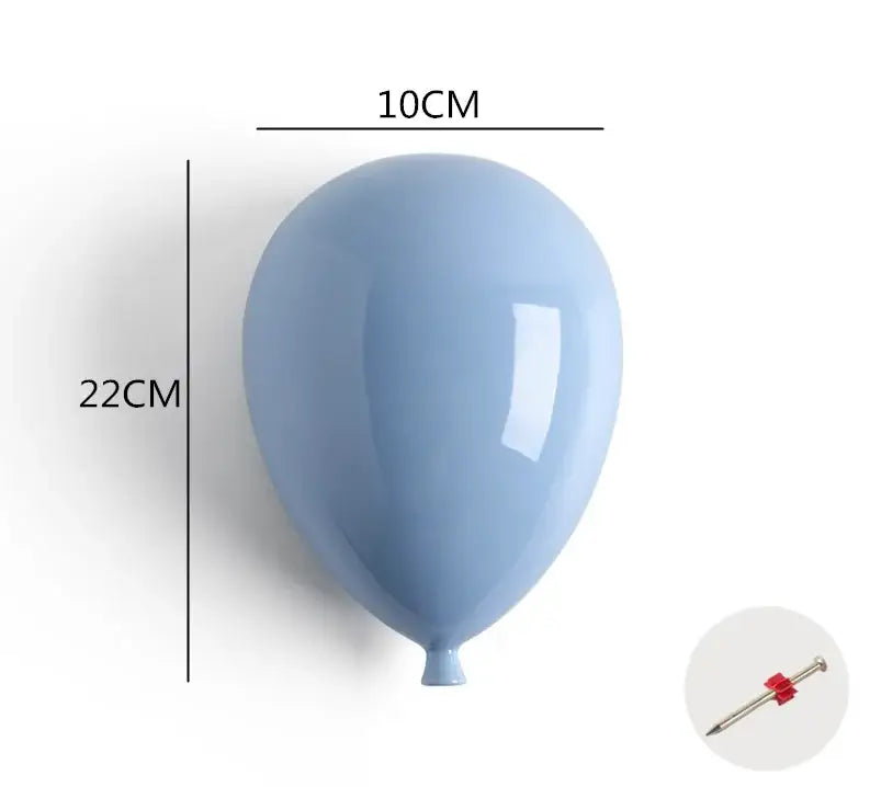 A sleek matte light blue ceramic balloon wall hanging decoration measuring 10cm wide and 22cm tall for children room