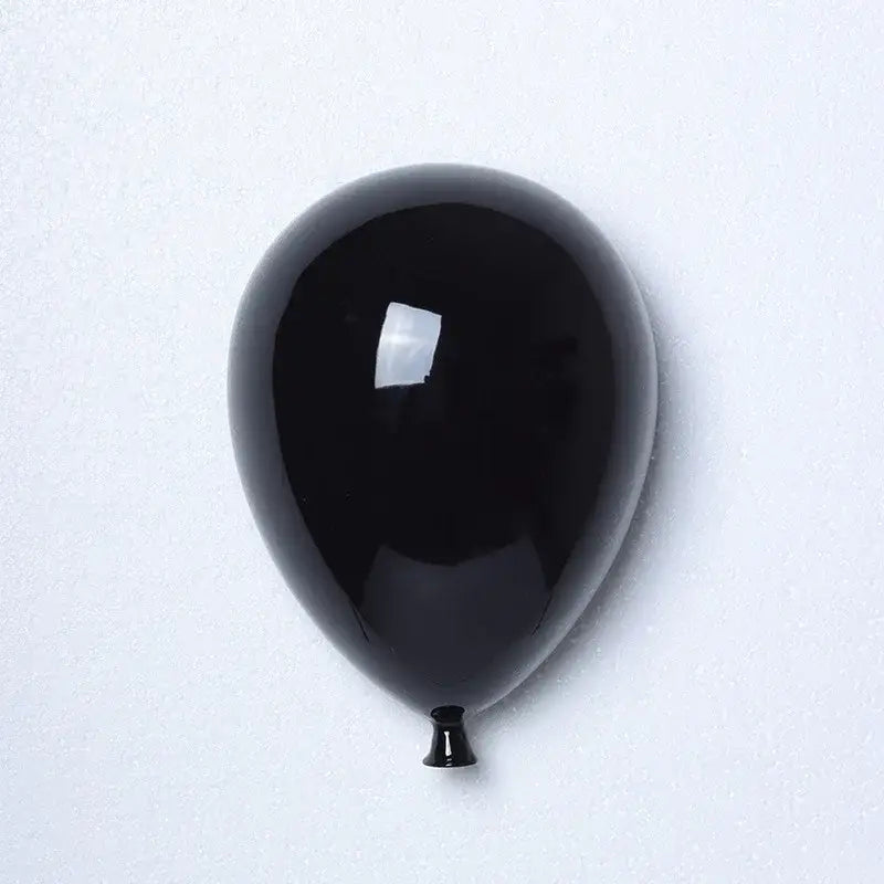 Glossy black ceramic balloon wall hanging decoration with reflective surface and tapered nozzle for children room