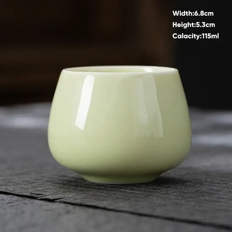 A smooth pale green ceramic kungfu tea cup with glossy finish and flared rim for decorbites ceramic kungfu set