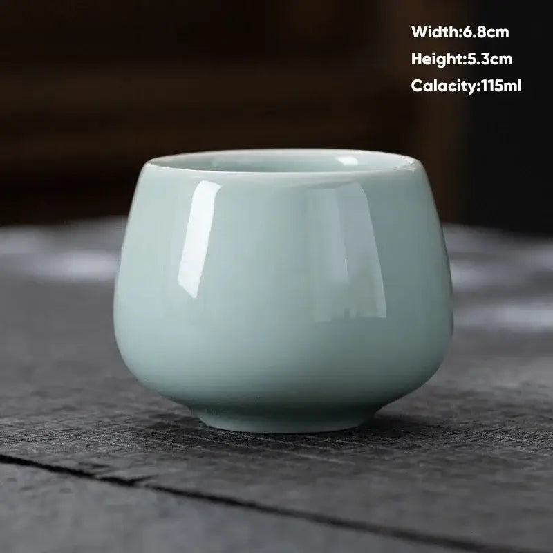 A smooth light green ceramic kungfu tea cup with a glossy finish from decorbites ceramic kungfu set for modern dining