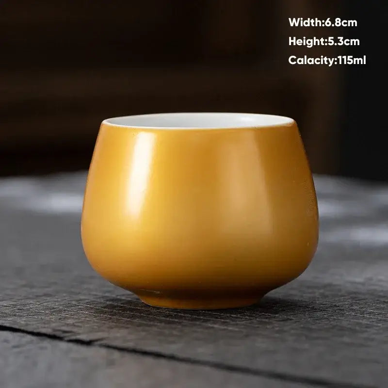 A smooth glossy amber decorbites ceramic kungfu tea cup with white interior for modern pastel dining room drinkware