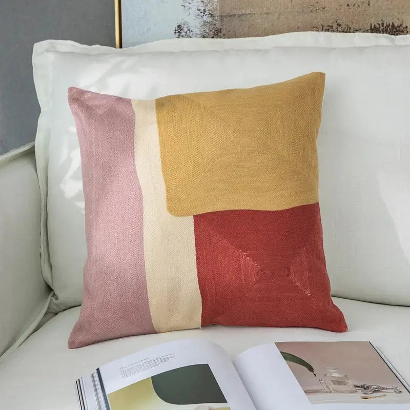 Modern pastel geometric cushion cover with embroidered abstract panels in pink yellow and red for living room decorbites geometric cushion
