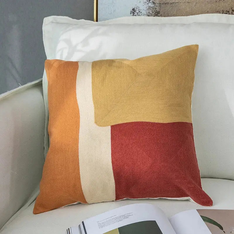 Modern pastel geometric cushion cover with embroidered orange, mustard yellow, and terracotta decorbites geometric cushion design