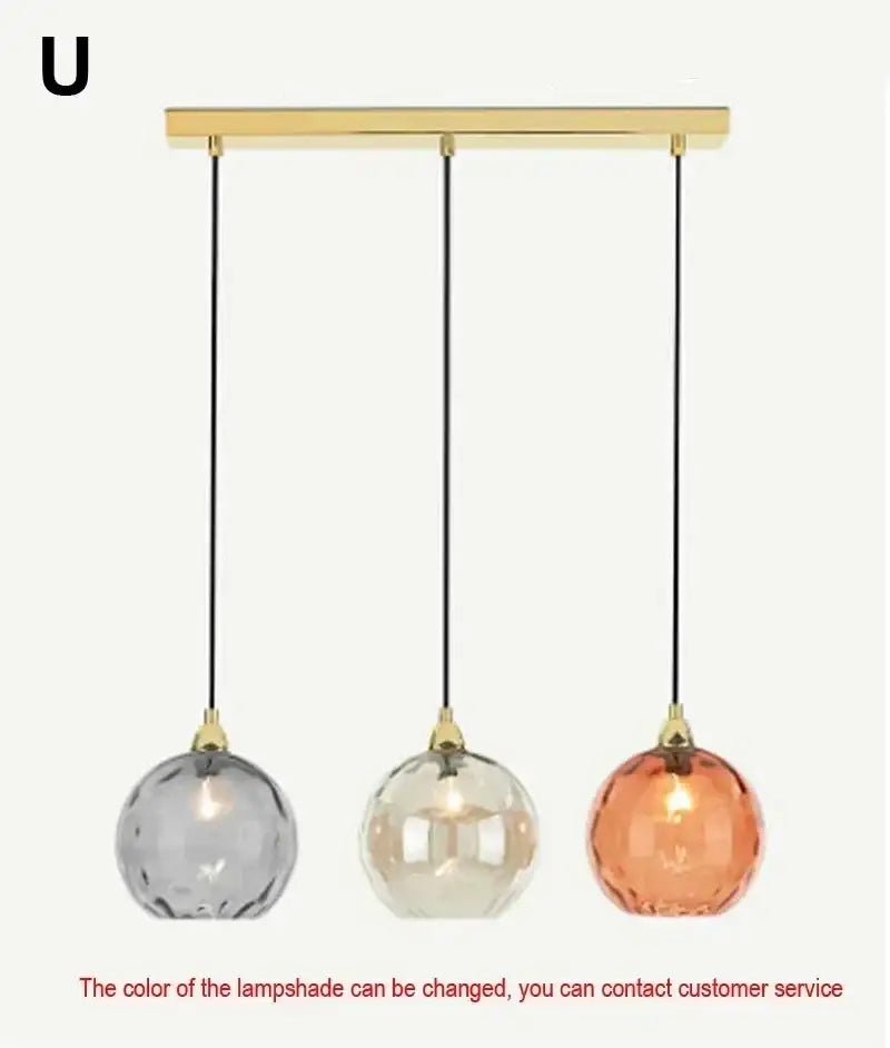A modern pendant light with polished chrome finish featuring a gold-toned bar and pastel glass globe shades