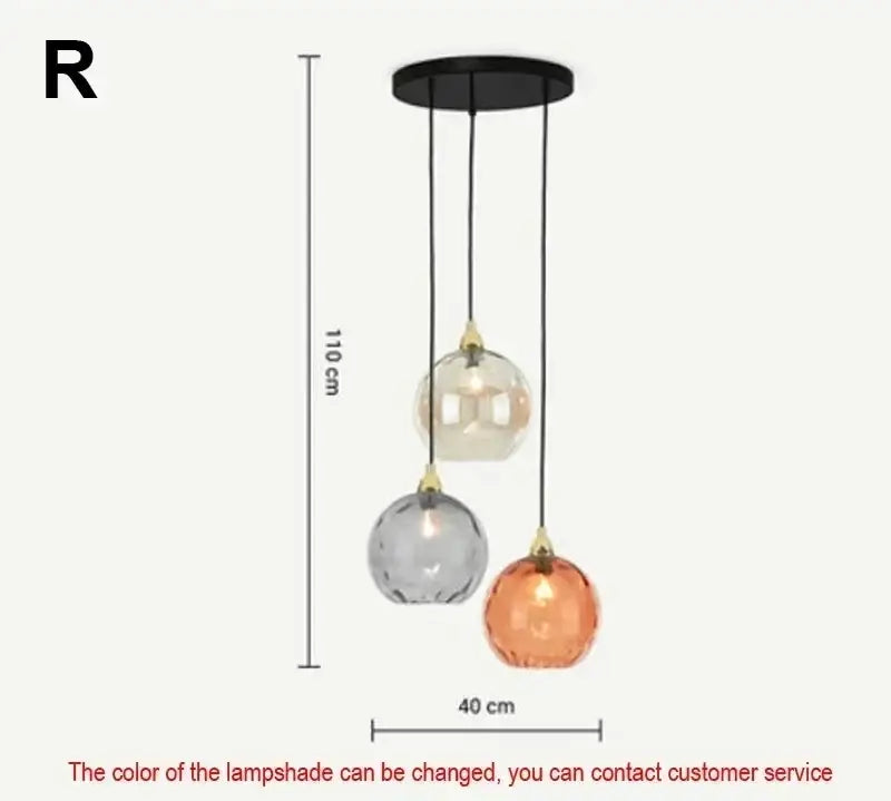 Modern pastel glass pendant light with three-tiered frosted globes in clear gray and amber and polished chrome mount