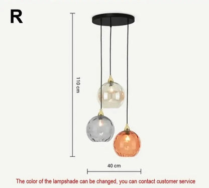 Modern pastel glass pendant light with three-tiered frosted globes in clear gray and amber and polished chrome mount